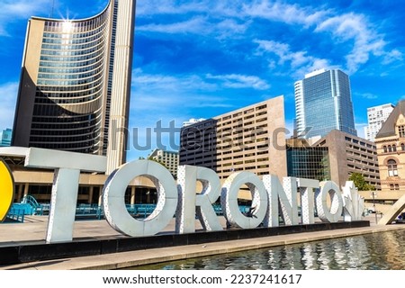 Toronto sign and city hall at Nathan Phillips Square in Toronto in a sunny day, Ontario, Canada