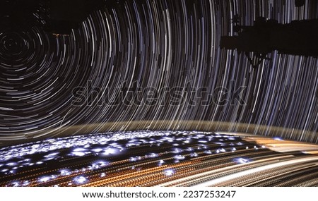 Time-lapse photography of star trails taken on the international space station from outer space. Night Lights. Digitally enhanced. Elements of this image furnished by NASA.  