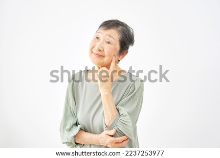 Asian old woman thinking in white background Royalty-Free Stock Photo #2237253977