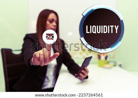 Hand writing sign Liquidity. Concept meaning Cash and Bank Balances Market Liquidity Deferred Stock