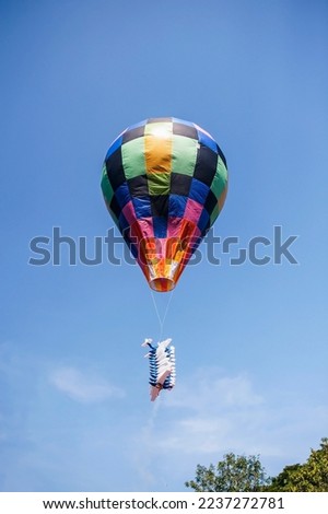 Balloons made of colorful paper filled with hot air inside are released into the sky.