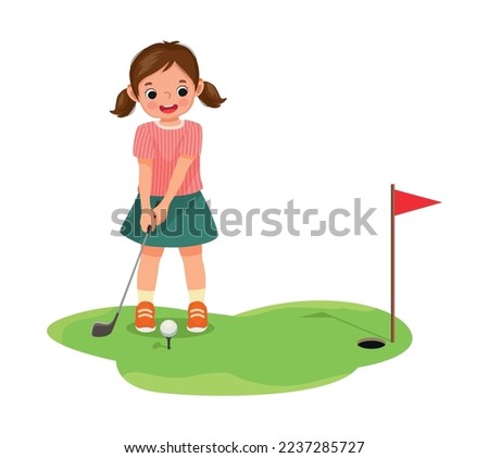 Cute little boy playing golf ready to hit ball aiming at the hole