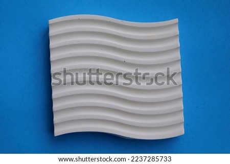 Striped coasters from cement crafts on a blue background, eco-friendly craft business, aesthetic interior items