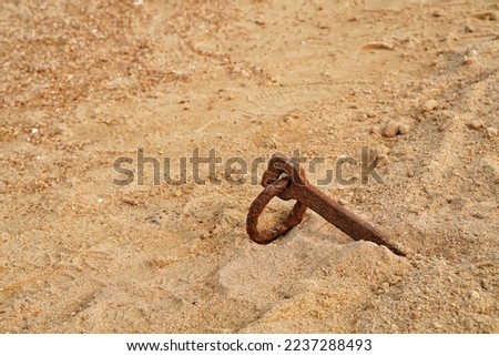 rusty anchor at the beach sand