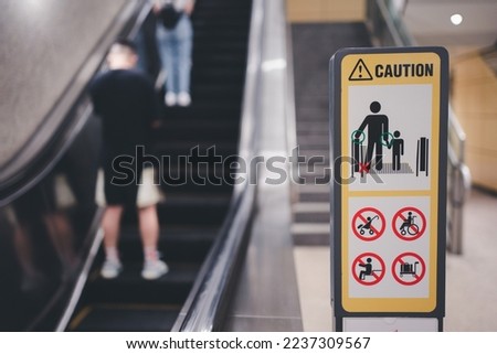 Set escalator safety sign at MRT Station in Singapore.