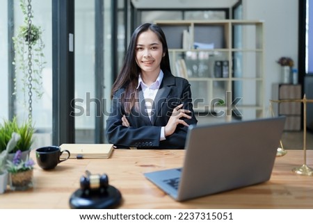 Portrait of a Asian woman lawyer studying a lawsuit for a client before going to court.