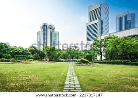 Modern urban business buildings behind lawn