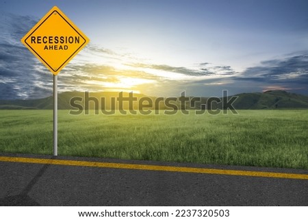 Street with recession sign with sunset sky background