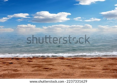 beautiful sunny sky and waves on a sandy sea beach
