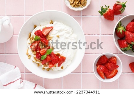 Yogurt with strawberry. Plain white greek yogurt with fresh berries and granola. Healthy food, breakfast. Top view Royalty-Free Stock Photo #2237344911