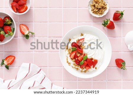 Yogurt with strawberry. Plain white greek yogurt with fresh berries and granola. Healthy food, breakfast. Top view Royalty-Free Stock Photo #2237344919