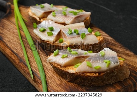Sandwiches with salty herring and spring onion Royalty-Free Stock Photo #2237345829
