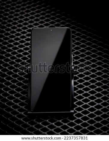 Smartphone with black screen off on black background. Royalty-Free Stock Photo #2237357831