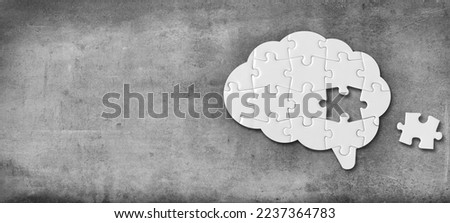 Brain shaped white jigsaw puzzle on concrete wall background, a missing piece of the brain puzzle, mental health and problems with memory Royalty-Free Stock Photo #2237364783