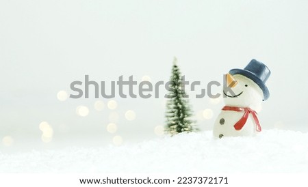 Merry Christmas background with snow, colorful bokeh backdrop.