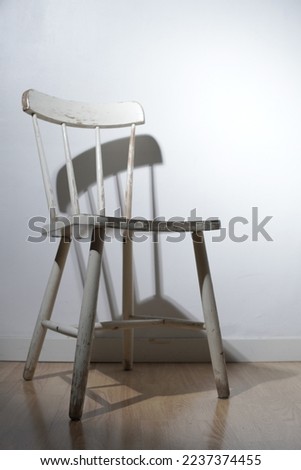 white wooden viantage chair on wooden floor