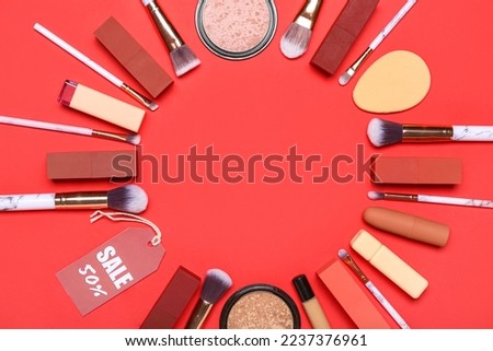 Frame made of cosmetic products and sale tag on red background