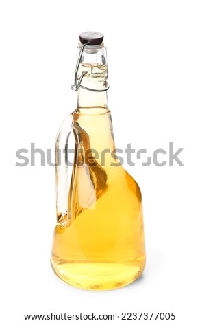 Bottle of fresh apple cider vinegar on white background