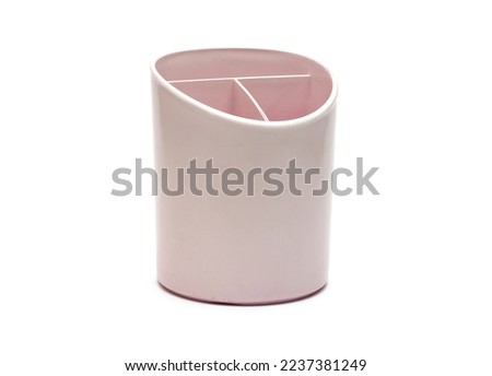 Used plastic pen or pencil holder box on isolated white background Royalty-Free Stock Photo #2237381249