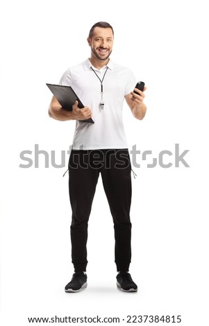 Sports coach with a whistle holding a clipboard and a stopwatch isolated on white background

