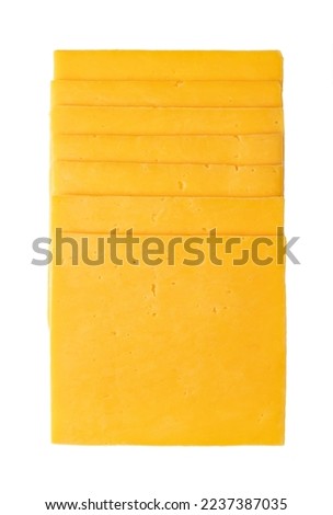 Stack of cheddar cheese slices, sliced natural cheese, sharp-tasting and colored orange with annatto, a natural food coloring. Close-up, from above, isolated on white background, macro food photo. Royalty-Free Stock Photo #2237387035