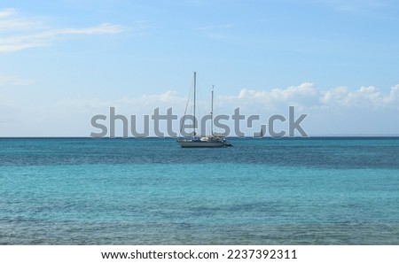 Blue sea with a monohull under a beautiful blue sky Royalty-Free Stock Photo #2237392311