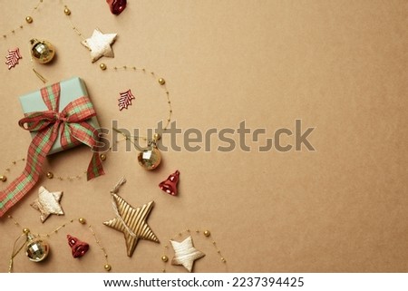 Christmas ornament and gift box on brown background. Christmas winter decoration. flat lay, top view, copy space