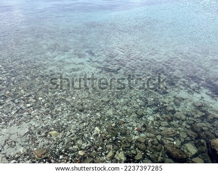 Transparent sea surface, stones on the sea bottom 