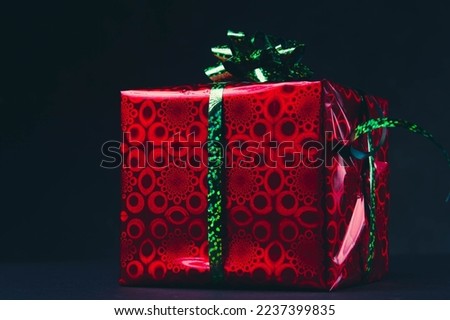 New Year's gift on a black background. Buying gifts The price tag on the New Year's box..