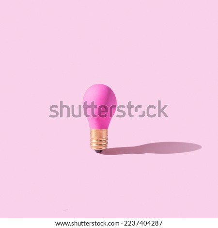 Pink lamp on pink background. Creative idea or startup concept. Monochrome. High quality photo