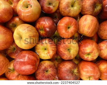Piles of apples displayed on supermarket. Red apples during the fall harvest.