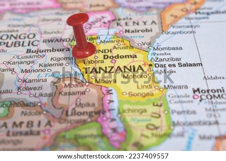 Red Push Pin Pointing on Tanzania World Map Close-Up View Stock Photograph