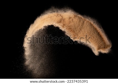 Small size fine Sand flying explosion, Golden grain wave explode. Abstract cloud fly. Yellow colored sand splash silica in Air. Black background Isolated high speed shutter, throwing freeze shot Royalty-Free Stock Photo #2237435391