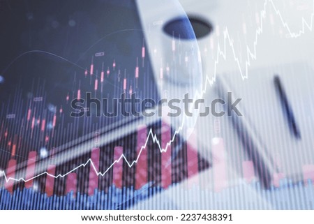 Abstract creative financial graph with world map on modern laptop background, forex and investment concept. Multiexposure