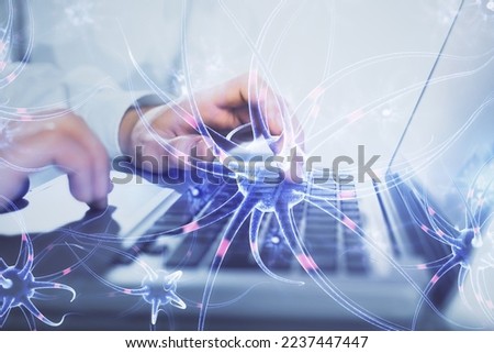 Neuron hologram with man working on computer on background. Education concept. Double exposure. Royalty-Free Stock Photo #2237447447