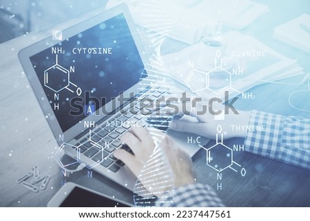 DNA hologram with businessman working on computer on background. Concept of bioengineering. Double exposure.