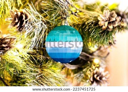 New Year's glass ball with the flag of Gay man against a colorful Christmas background
