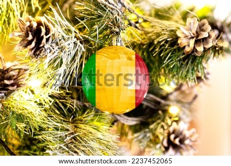 New Year's glass ball with the flag of Mali against a colorful Christmas background