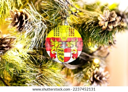 New Year's glass ball with the flag of Carinthia against a colorful Christmas background