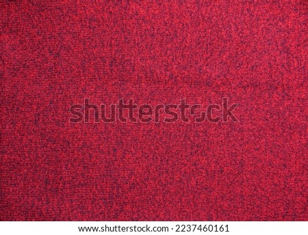 Red knitted wool Christmas background. Warm sweater atmosphere. Christmas wallpaper. Texture of woolen or acrylic jersey. Basis for winter design