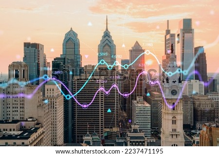 Aerial panoramic skyline of Philadelphia financial downtown, Pennsylvania, USA. City Hall Clock Tower at sunset. Forex candlesticks and bar graph hologram. The concept of internet trading, brokerage