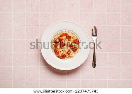 top view of pasta with meat near  fork on pink background Royalty-Free Stock Photo #2237475745
