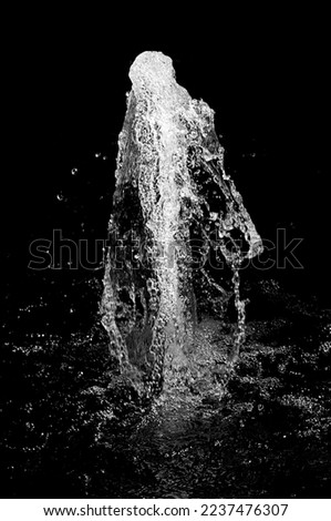 Vertical splash white water over black background Royalty-Free Stock Photo #2237476307