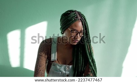 Contemplative African American young woman with braided hairstyle. One pensive black adult girl with box braids style. Thoughtful emotion