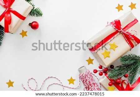 festive new year layout with place for text. christmas decorations, gifts and fir branches on a white background. top view. flat lay. copy space. red and green colors.