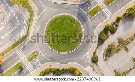 Aerial view on a roundabout road junction. Royalty-Free Stock Photo #2237490961