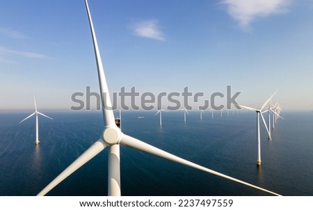 Drone Aerial view at Windmill park with windmills turbines in the ocean Royalty-Free Stock Photo #2237497559