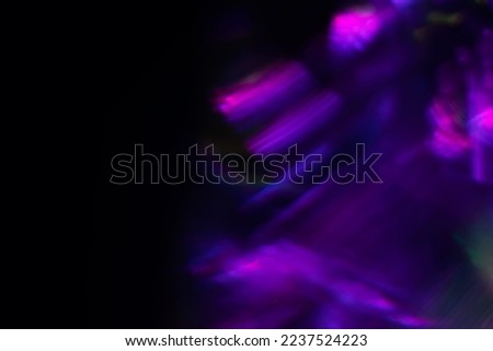 Blur neon light. Lens flare overlay. Bokeh fluorescent flash gleam. Defocused blue purple color flecks on dark black abstract background. Royalty-Free Stock Photo #2237524223