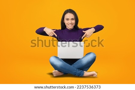 Happy young girl using laptop