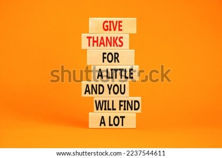 Give thanks symbol. Concept words Give thanks for a little and you will find a lot on wooden blocks. Beautiful orange background copy space. Business motivational give thanks concept